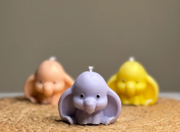 Cute pastel elephant shaped decorative wax candles in blue, yellow, and pink